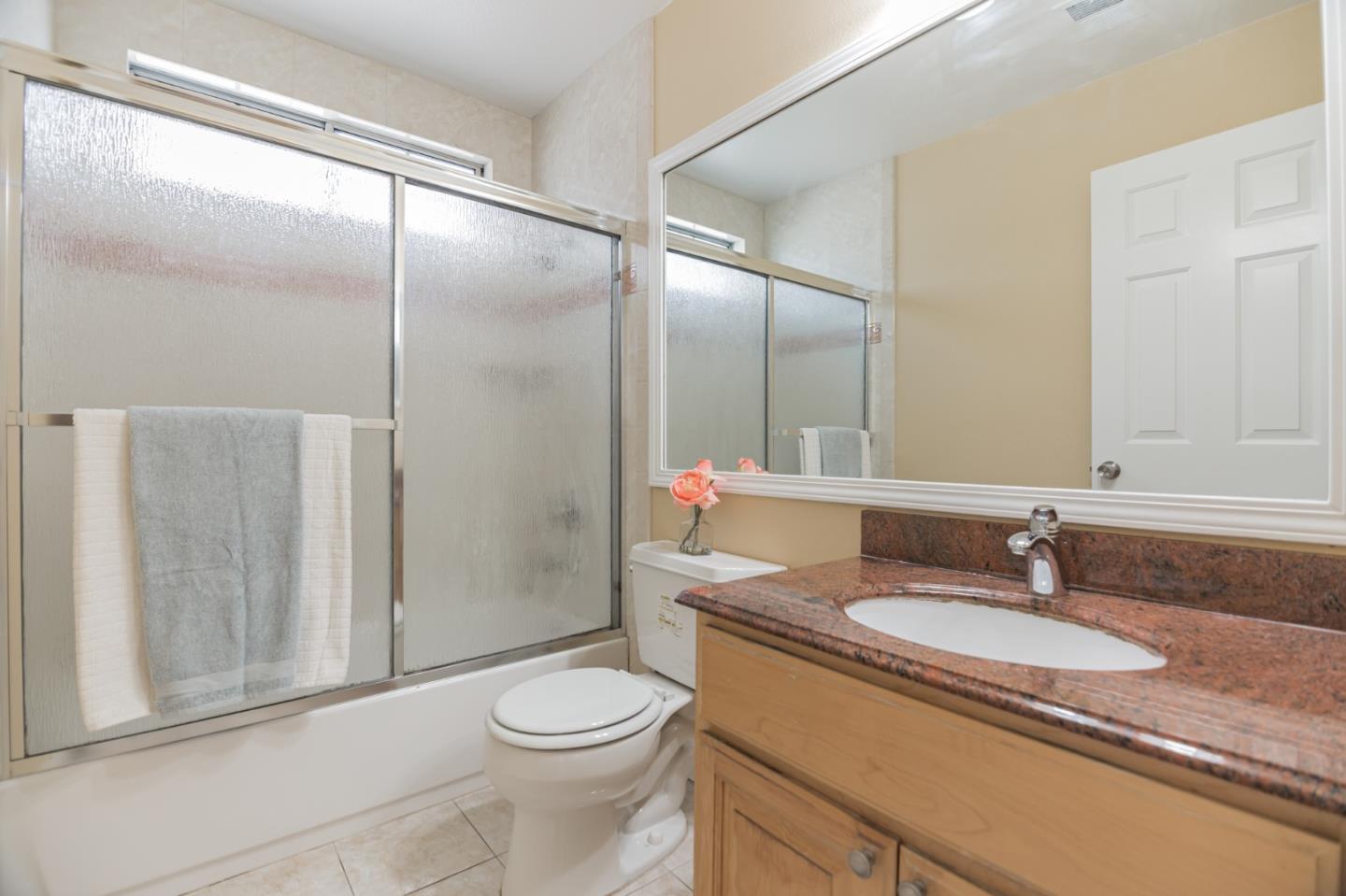 933 Coventry Way Milpitas, CA 95035 - Photo 22 of 30 a bathroom with a granite countertop sink toilet and shower