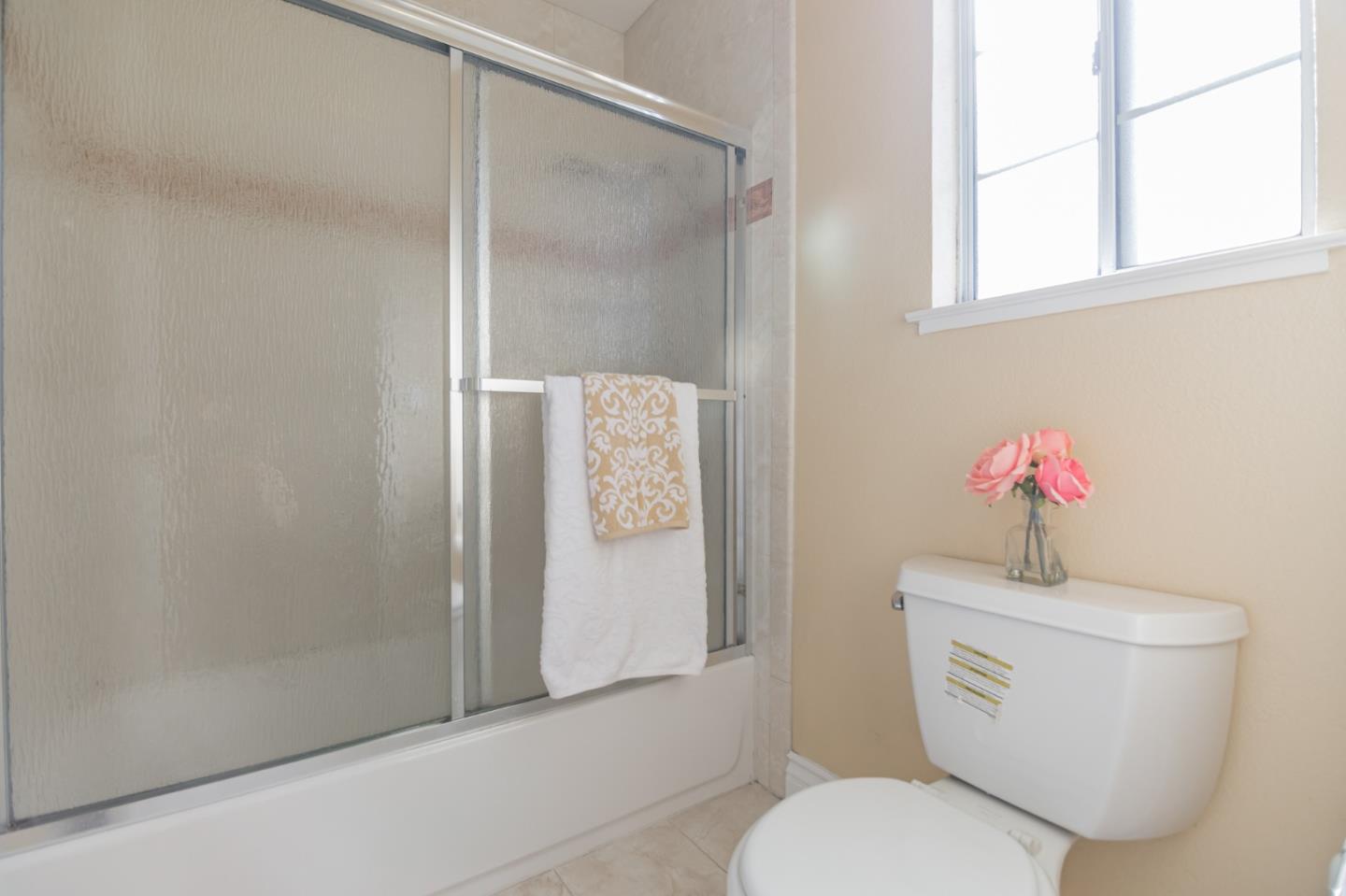 933 Coventry Way Milpitas, CA 95035 - Photo 28 of 30 a white toilet sitting next to a bathroom sink