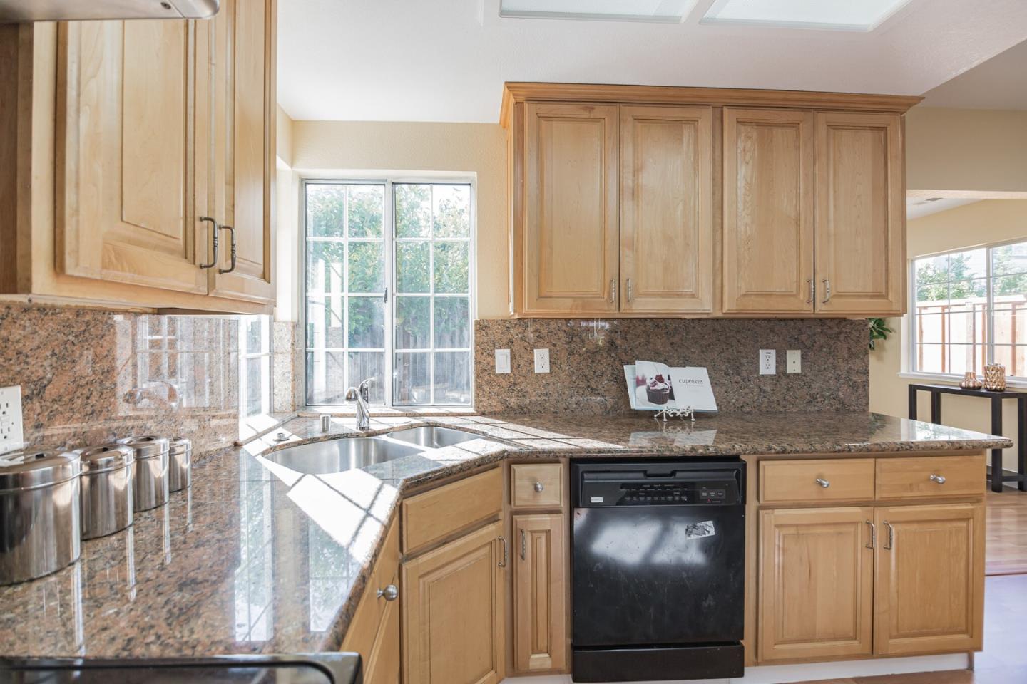 933 Coventry Way Milpitas, CA 95035 - Photo 9 of 30 a kitchen with stainless steel appliances granite countertop a sink a stove and cabinets
