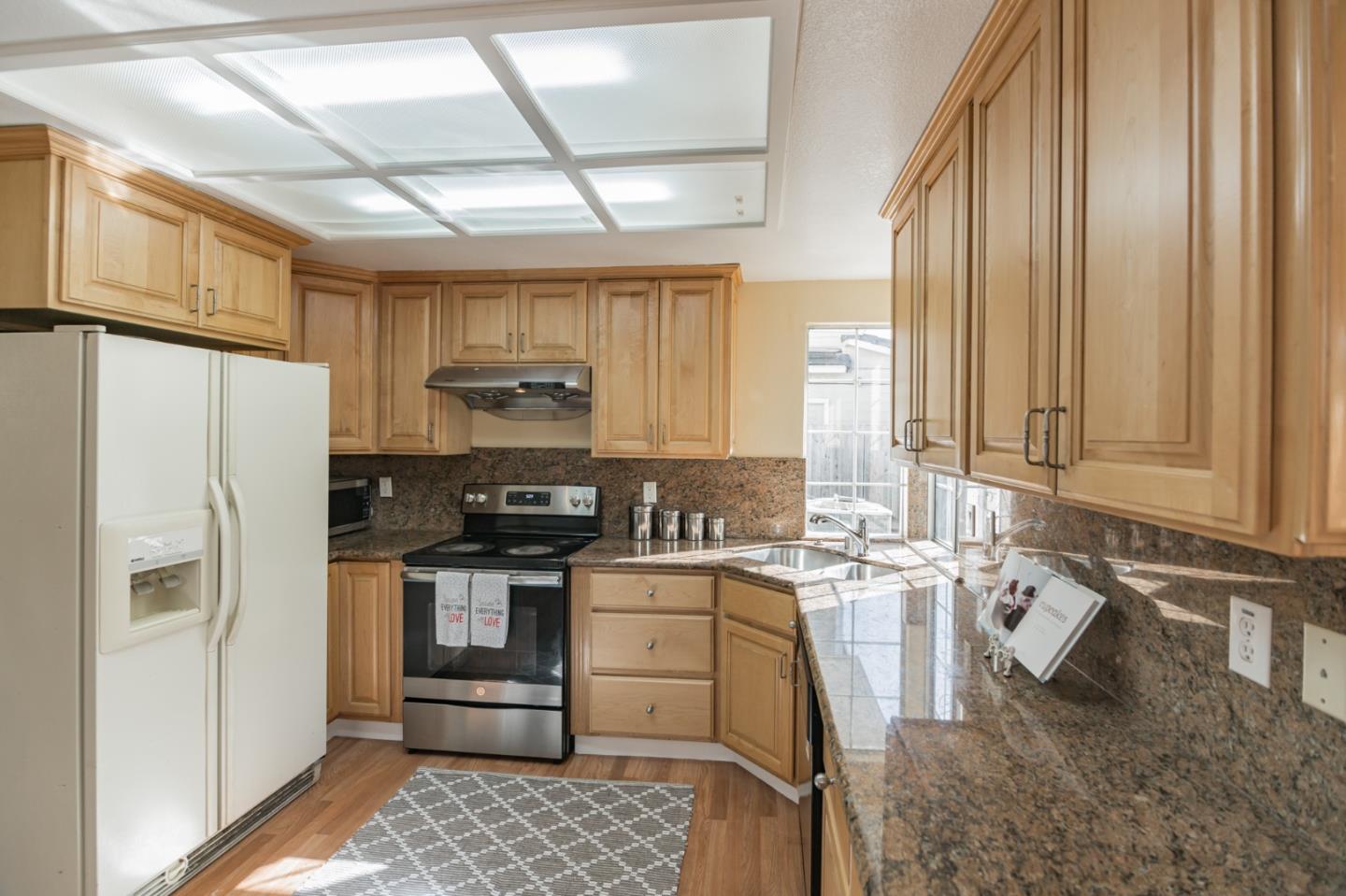 933 Coventry Way Milpitas, CA 95035 - Photo 10 of 30 a kitchen with stainless steel appliances granite countertop a refrigerator a stove and a sink