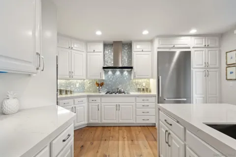 a kitchen with stainless steel appliances a refrigerator and a sink