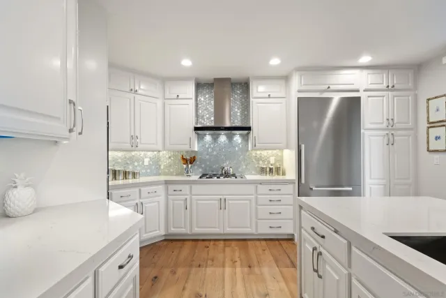 a kitchen with stainless steel appliances a refrigerator and a sink