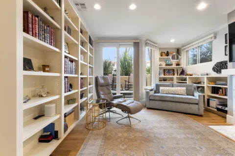 a bedroom with furniture and wooden floor