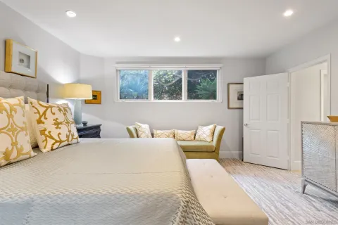 a bedroom with a bed and a painting on the wall