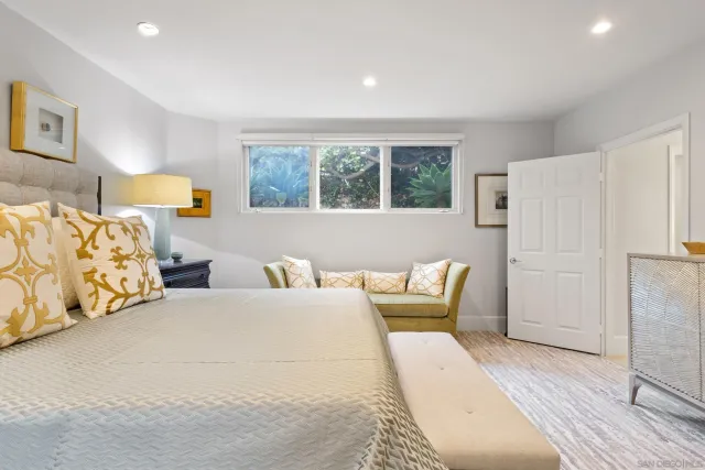 a bedroom with a bed and a painting on the wall