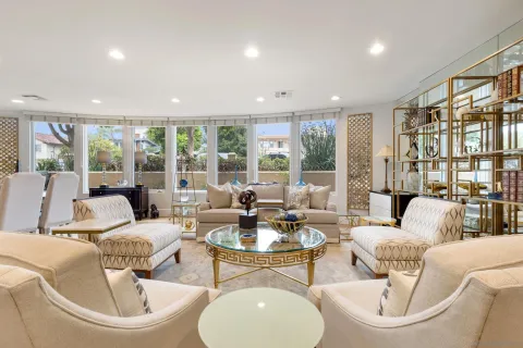 a living room with fireplace furniture and a large window