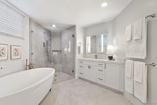 a large bed sitting in a bedroom next to a window