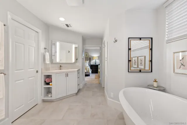 a bedroom with bed and a large mirror