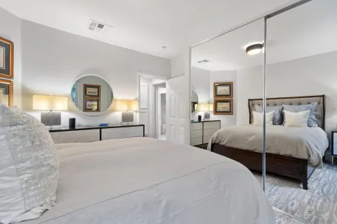 a front view of a building with cars parked