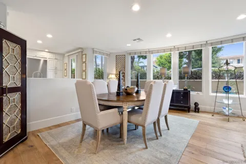 a living room with furniture and large windows