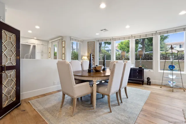a living room with furniture and large windows