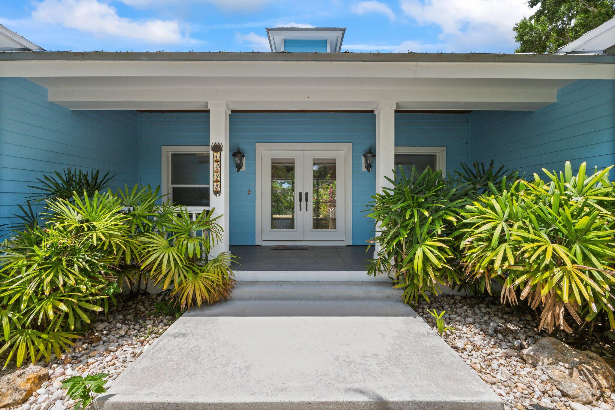1293 Southwest Heather Terrace Stuart, FL 34997 - Photo 11 of 80 a front view of a house with a garden