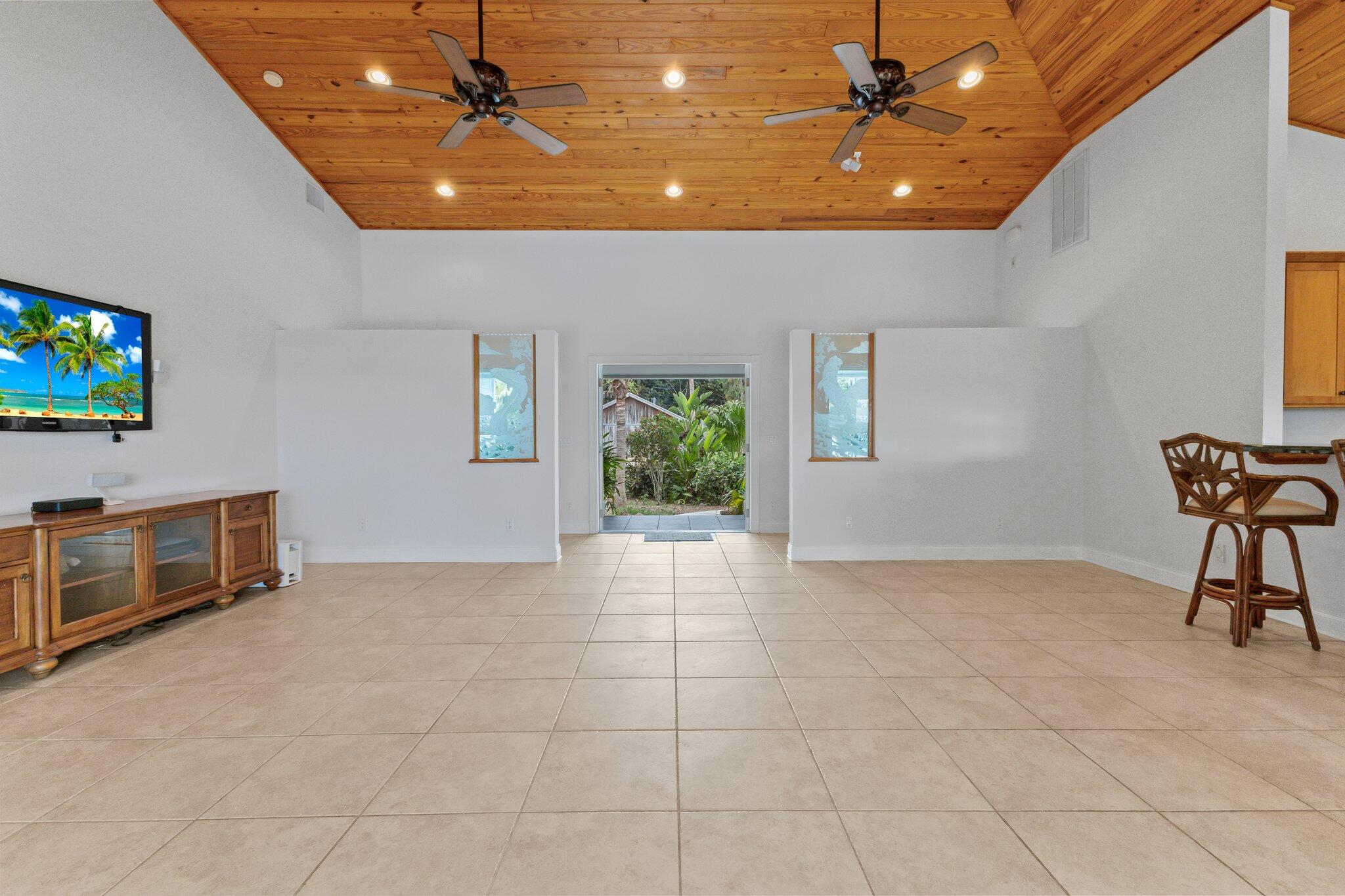 1293 Southwest Heather Terrace Stuart, FL 34997 - Photo 12 of 80 an empty room with windows and ceiling fan