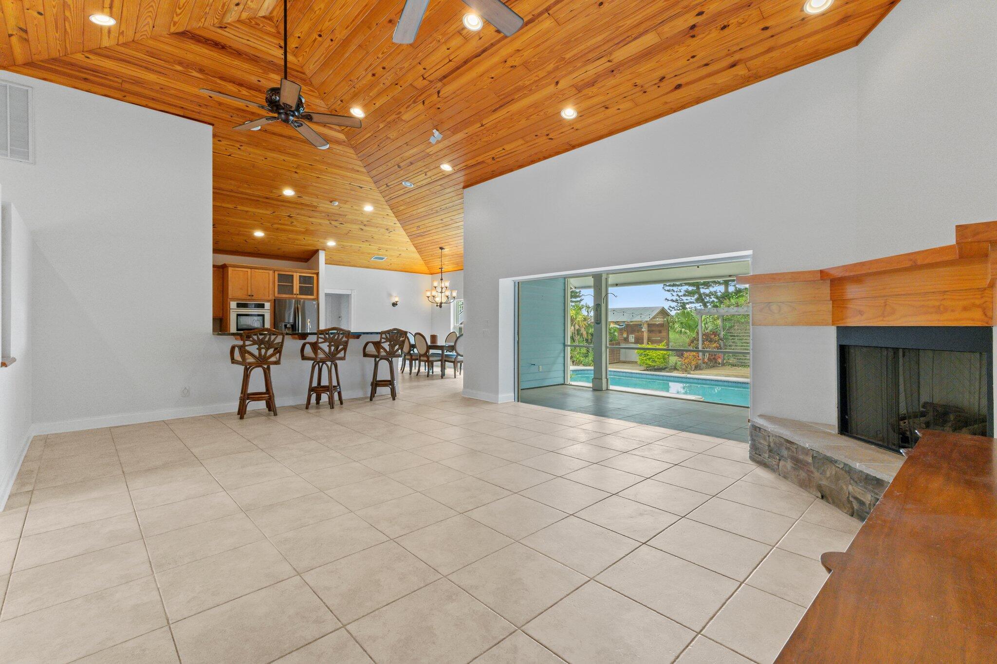 1293 Southwest Heather Terrace Stuart, FL 34997 - Photo 14 of 80 a view of a patio with table and chairs with wooden floor and fence