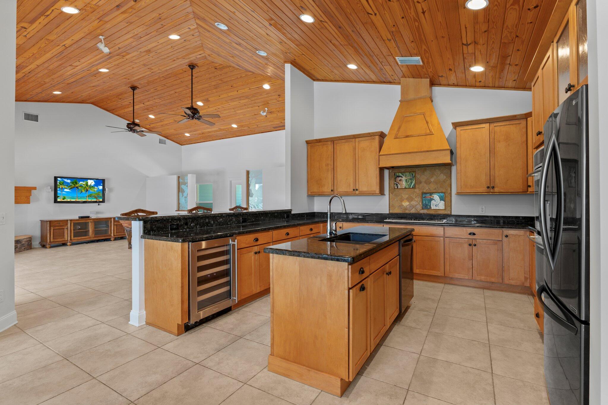 1293 Southwest Heather Terrace Stuart, FL 34997 - Photo 16 of 80 a kitchen with stainless steel appliances granite countertop a sink and a stove