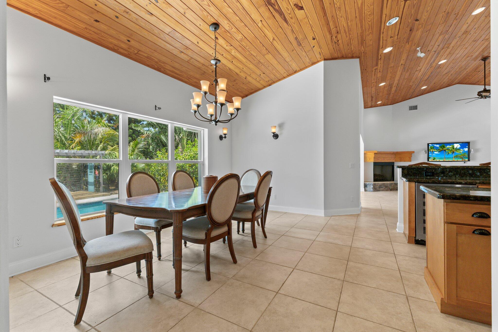 1293 Southwest Heather Terrace Stuart, FL 34997 - Photo 20 of 80 a dining room with furniture and a floor to ceiling window