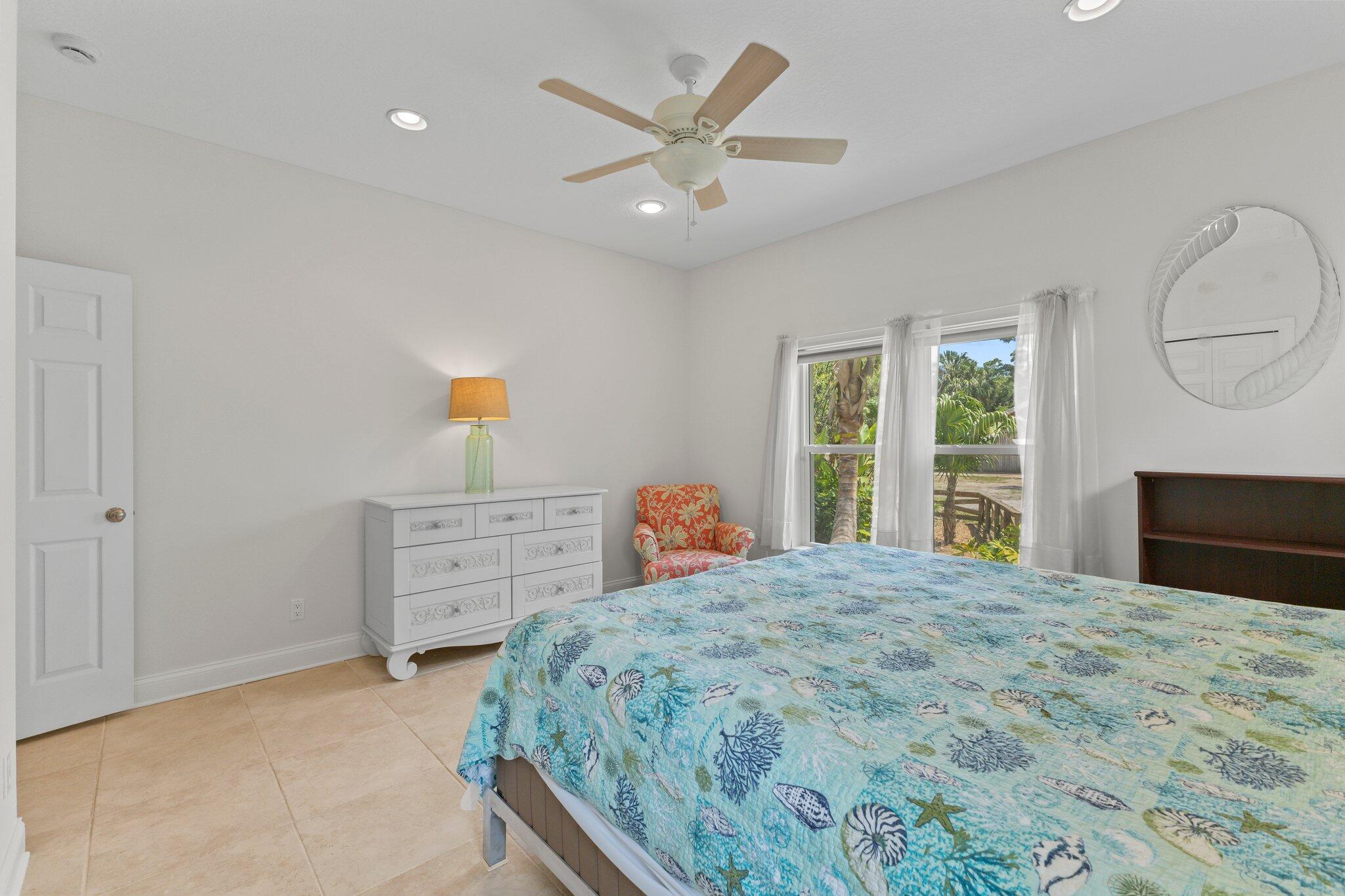 1293 Southwest Heather Terrace Stuart, FL 34997 - Photo 35 of 80 a bedroom with a bed and a dresser