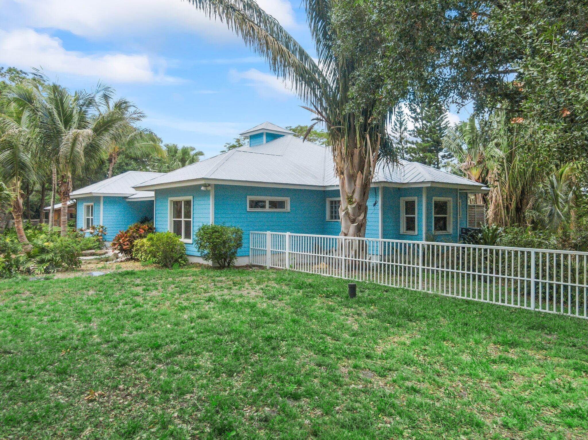 1293 Southwest Heather Terrace Stuart, FL 34997 - Photo 63 of 80 a front view of a house with a yard