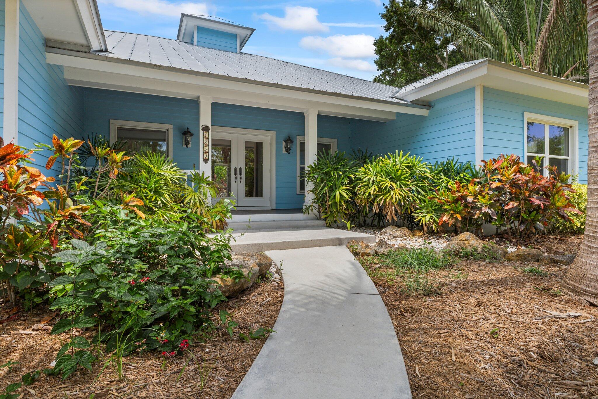 1293 Southwest Heather Terrace Stuart, FL 34997 - Photo 10 of 80 front view of a house