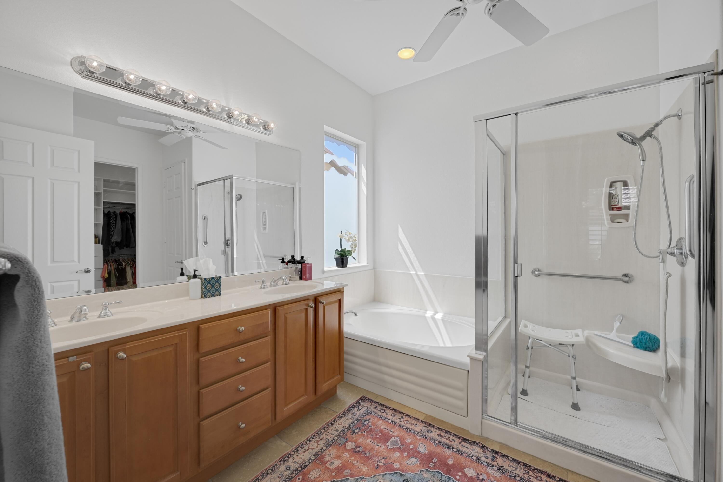 40092 Calle San Geronimo Indio, CA 92203 - Photo 20 of 48 a bathroom with a double vanity sink a mirror a bathtub and shower