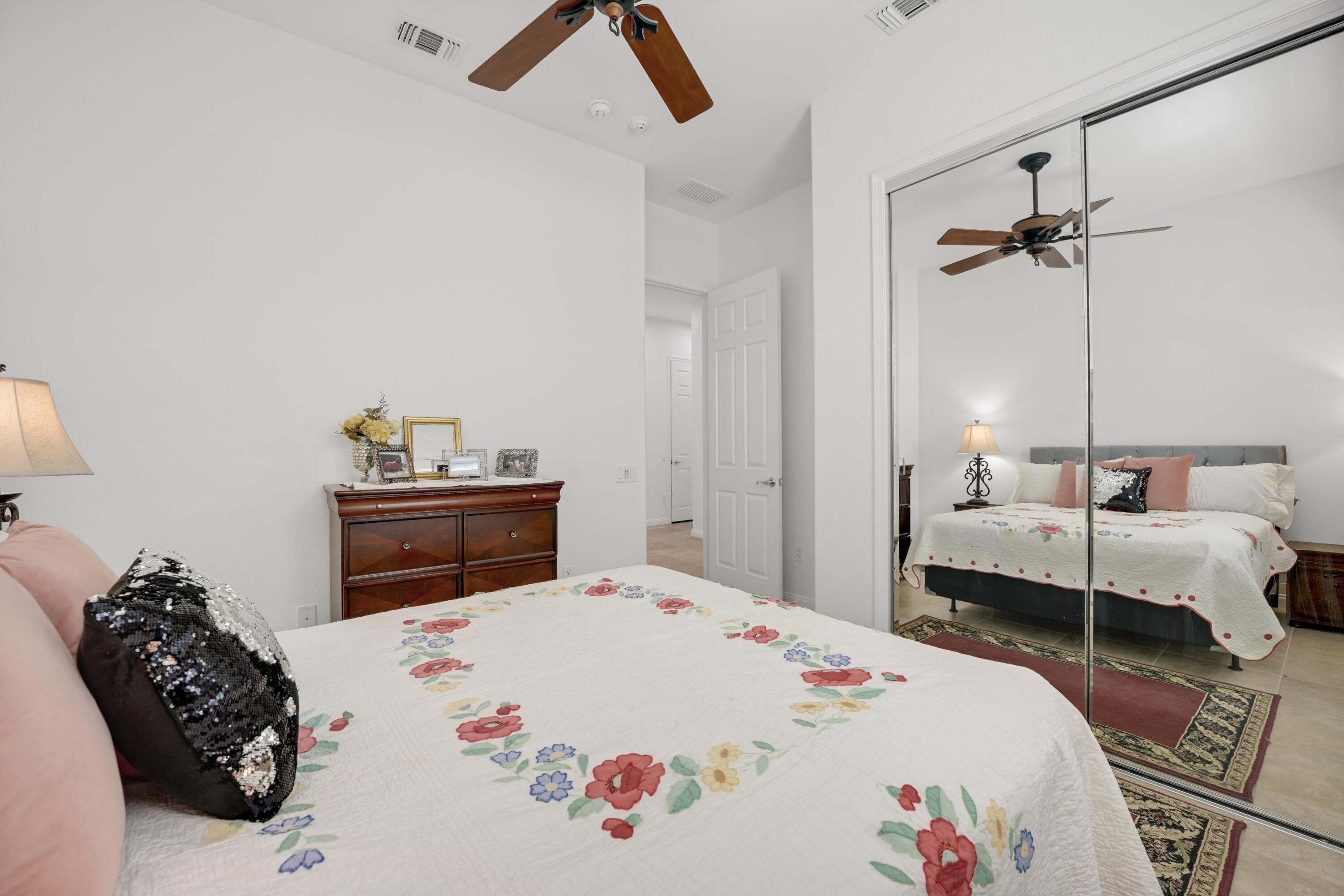 40092 Calle San Geronimo Indio, CA 92203 - Photo 23 of 48 a bedroom with a bed and a chandelier