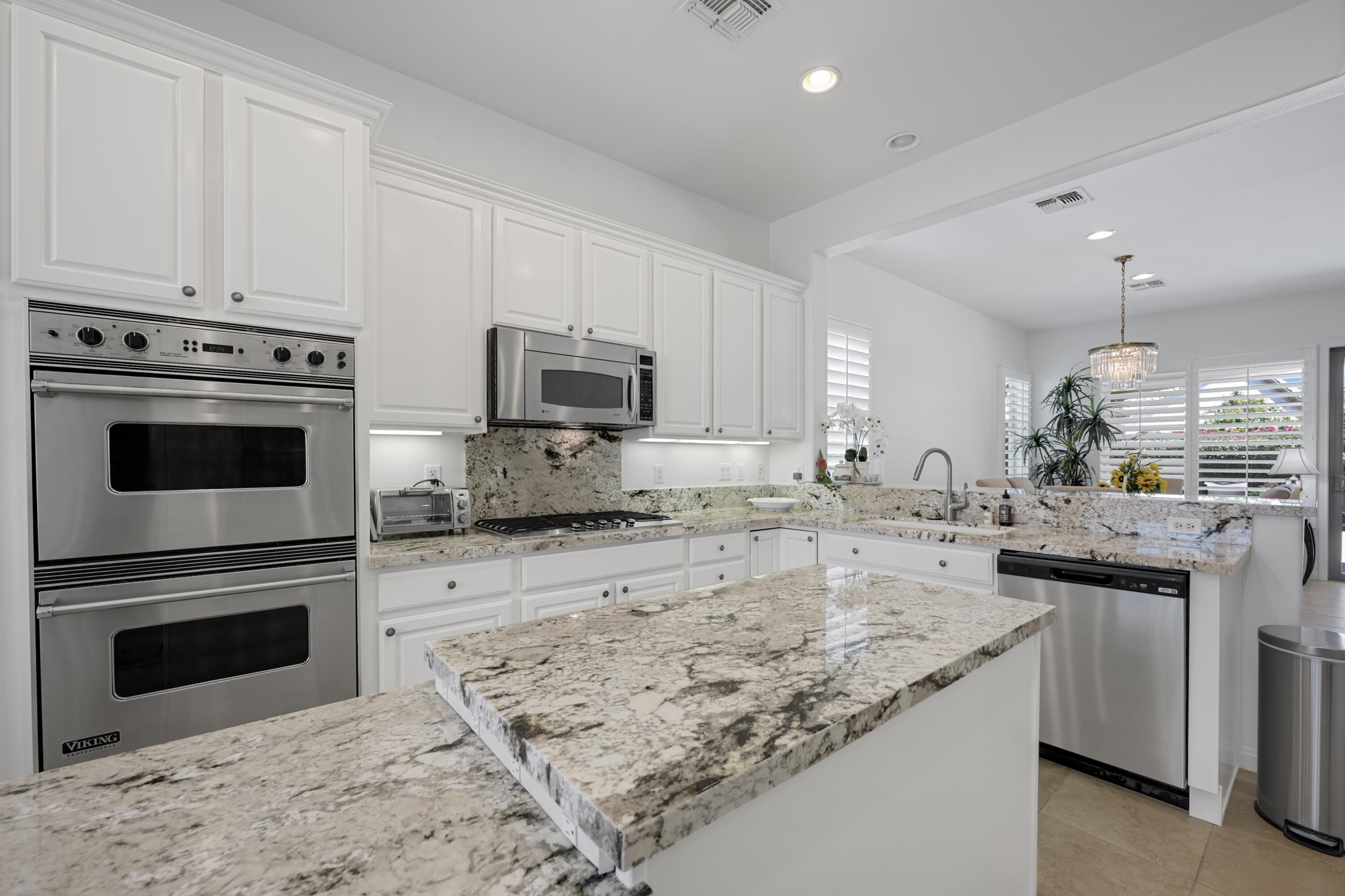 40092 Calle San Geronimo Indio, CA 92203 - Photo 8 of 48 a kitchen with granite countertop a sink stove and cabinets