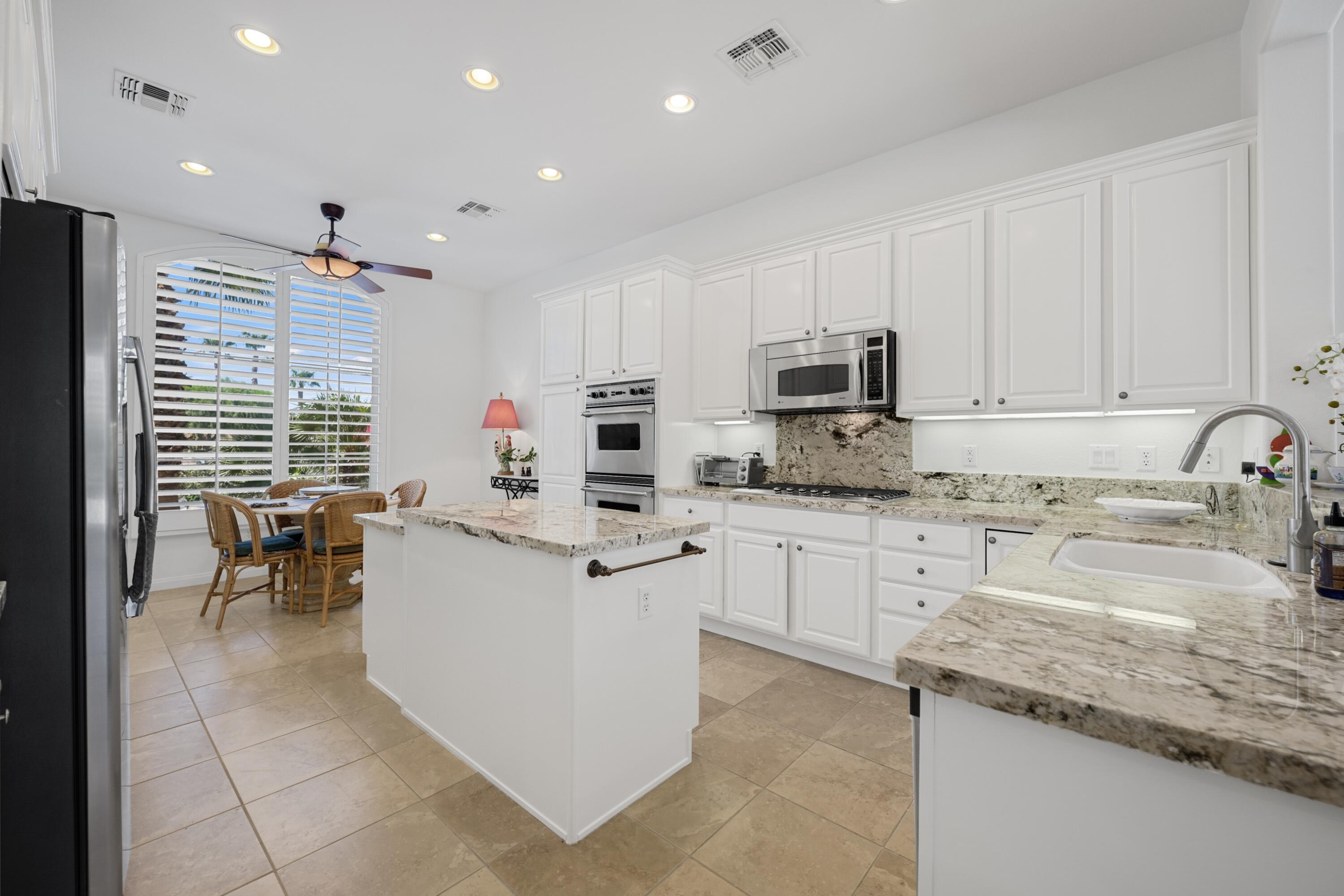 40092 Calle San Geronimo Indio, CA 92203 - Photo 9 of 48 a kitchen with a sink stove and cabinets