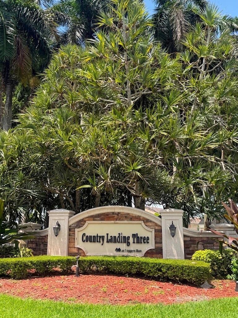 21070 Woodspring Avenue Boca Raton, FL 33428 - Photo 30 of 30 a sign board with a house in the background