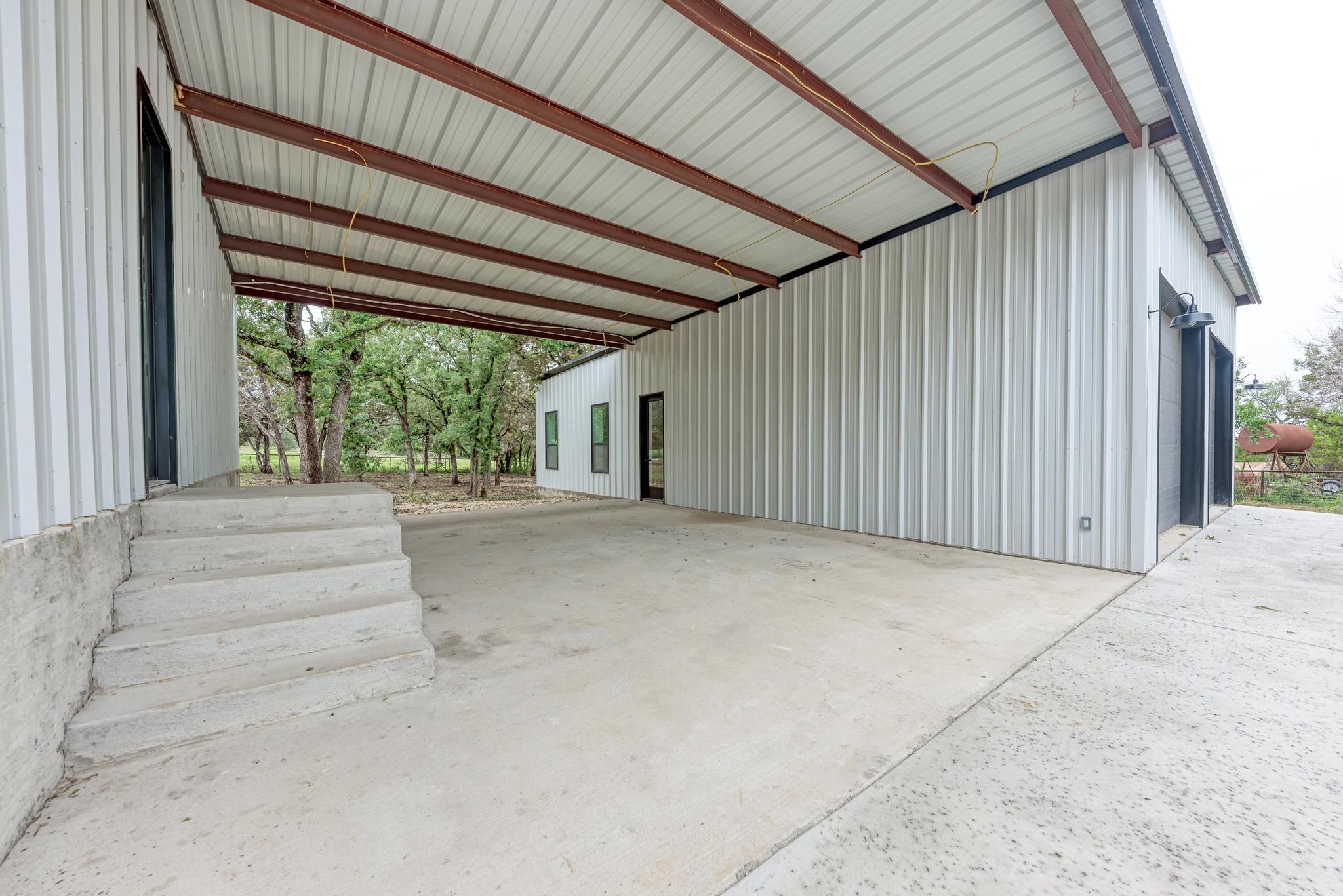 4190 West Fm 243 Bertram, TX 78605 - Photo 31 of 42 Garage featuring an attached carport