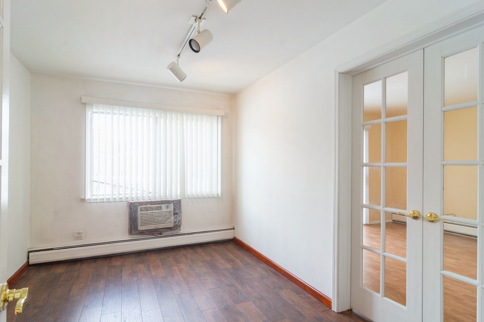 602 East Algonquin Road, Unit 109 Arlington Heights, IL 60005 - Photo 8 of 15 an empty room with wooden floor and windows