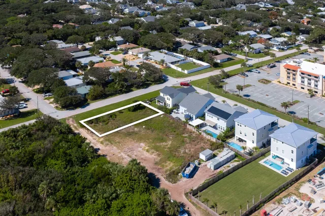 an aerial view of a tennis ground and a houses