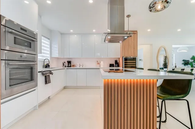 a spacious bedroom with a large bed and a chandelier