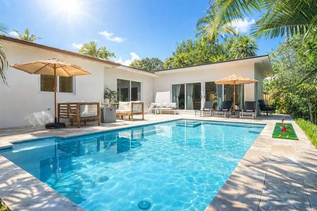 a bedroom with furniture and a large window
