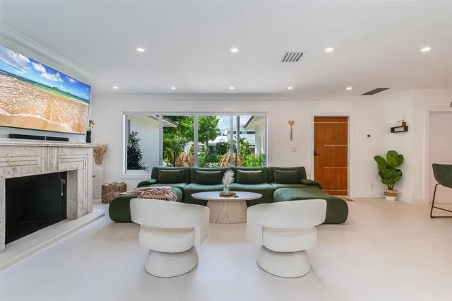 a kitchen with stainless steel appliances kitchen island granite countertop a refrigerator and a dining table