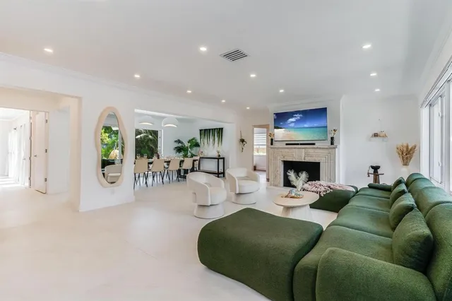 a living room with a table tennis ceiling fan and a rug