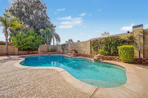 a view of a swimming pool with a yard