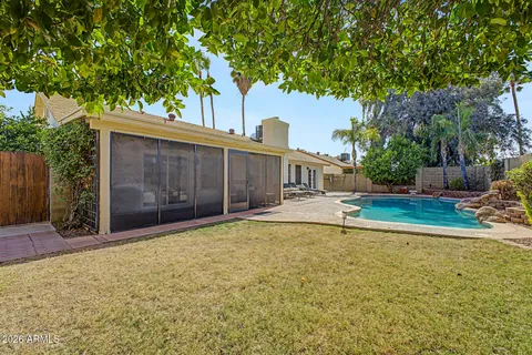 a view of a house with a yard and tree