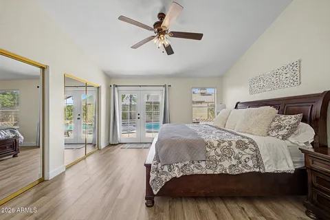 a bedroom with a large bed and a chandelier