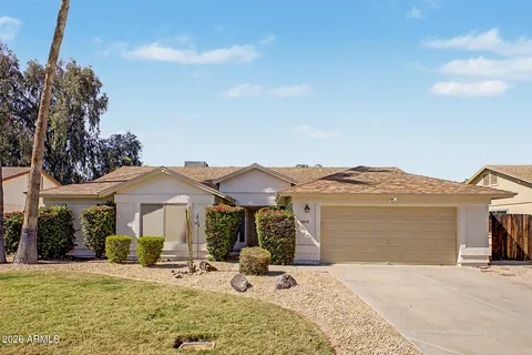 a view of a house with a yard and sitting area