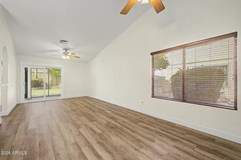 wooden floor in an empty room with a window