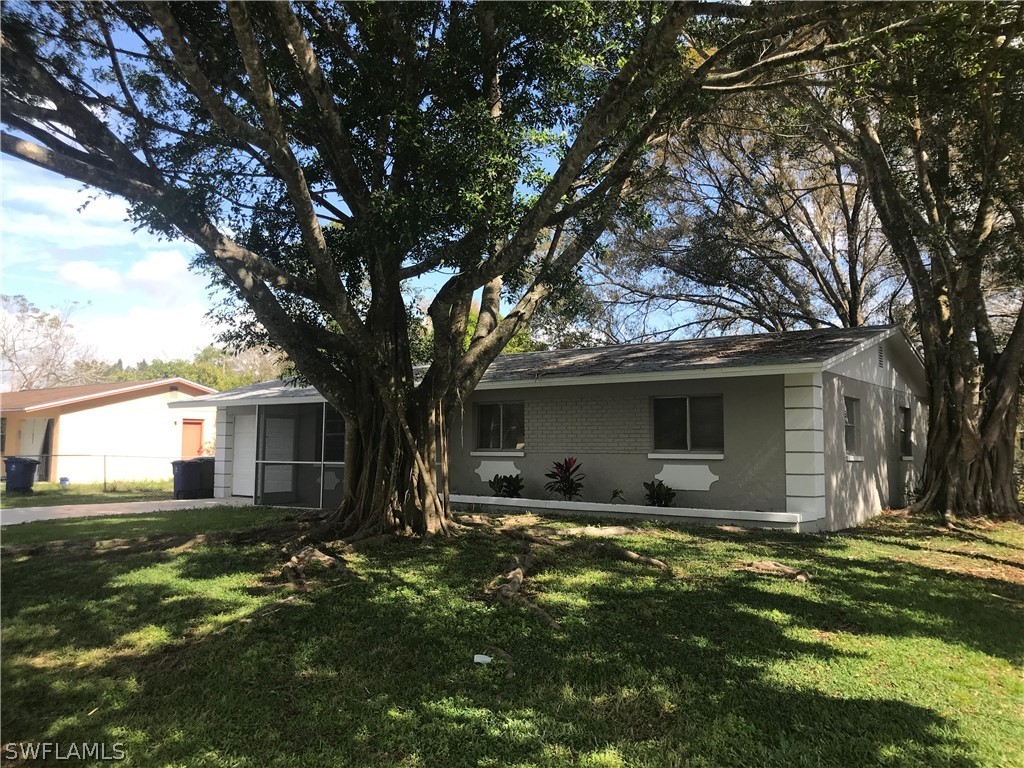 2316 Caladium Road Fort Myers, FL 33905 - Photo 1 of 18 a view of a house with yard and tree s