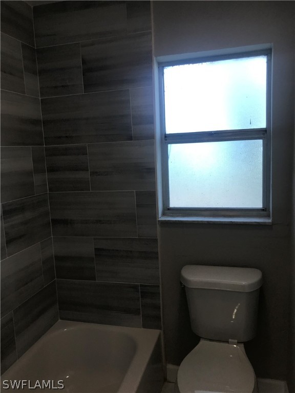 2316 Caladium Road Fort Myers, FL 33905 - Photo 8 of 18 a bathroom with a toilet a window and a shower