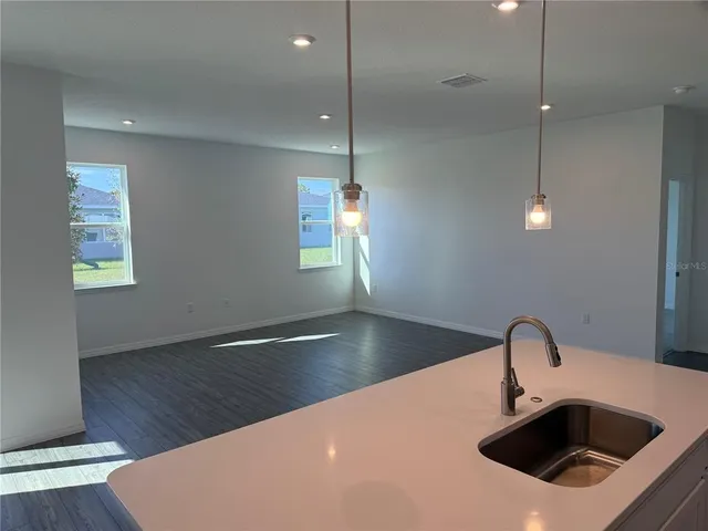a kitchen with kitchen island a sink stainless steel appliances and window