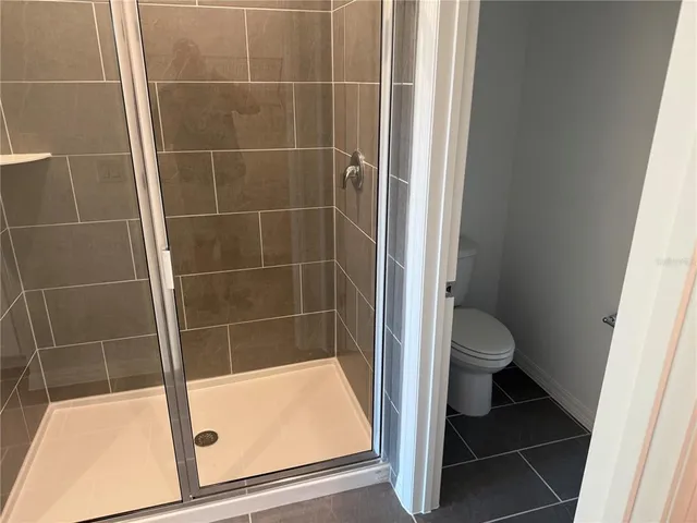 a bathroom with a toilet and a shower