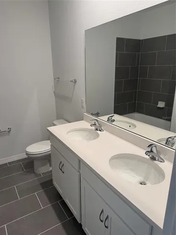 a bathroom with a sink toilet and a mirror