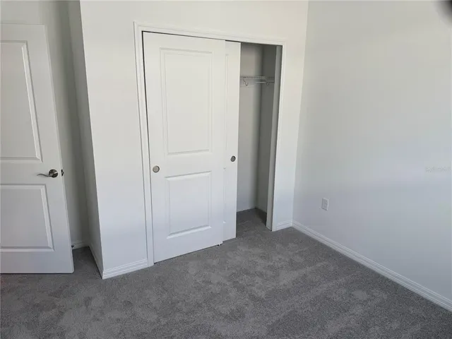 an empty room with closet area