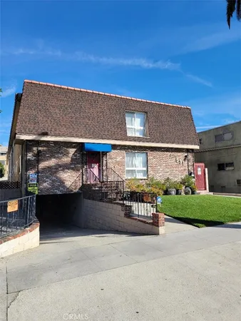 a view of house with outdoor space and parking