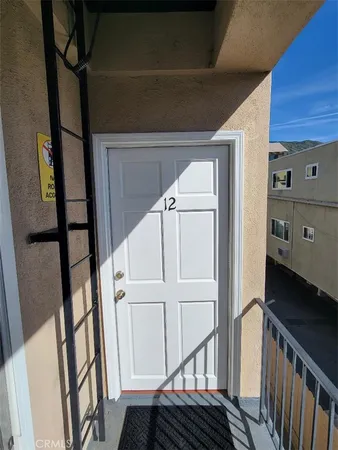 a view of a closet with wooden floor