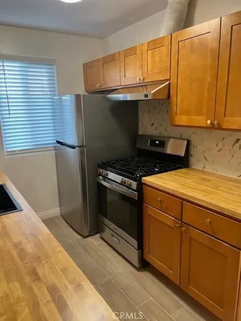 a kitchen with a sink a stove and a refrigerator