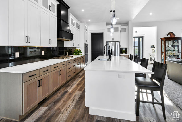 1952 Highway 118 Monroe, UT 84754 - Photo 24 of 88 Kitchen with premium range hood, backsplash, stainless steel appliances, a kitchen island with sink, and recessed lighting
